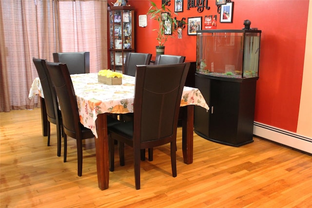 dining room featuring light hardwood / wood-style floors and a baseboard heating unit