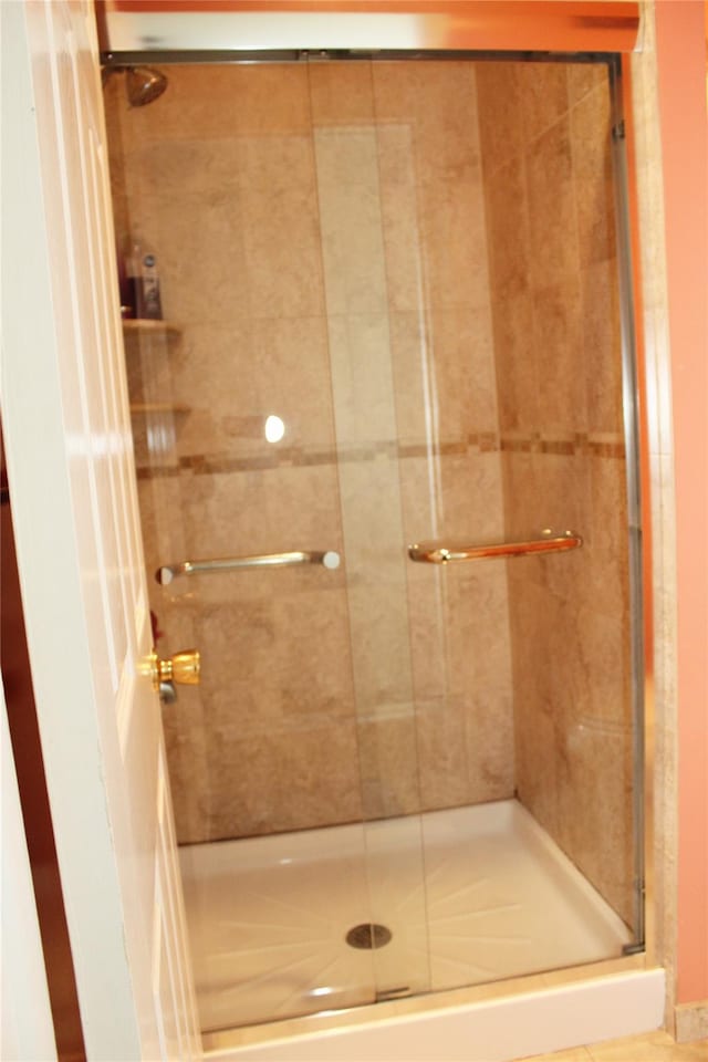 bathroom with a shower with door