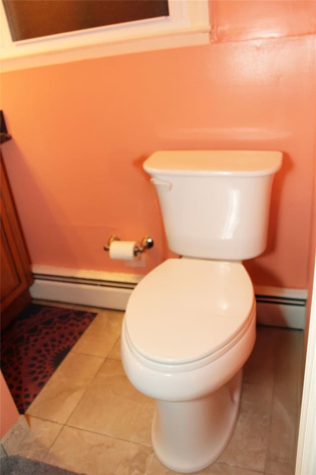 bathroom featuring tile patterned floors, toilet, and baseboard heating