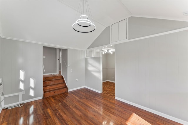 interior space with vaulted ceiling, wooden walls, and dark hardwood / wood-style floors