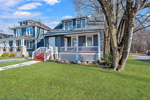 view of front of property with a porch and a front lawn