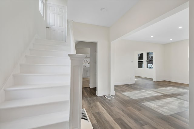 stairs with hardwood / wood-style flooring