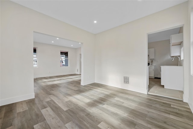 spare room with light wood-type flooring