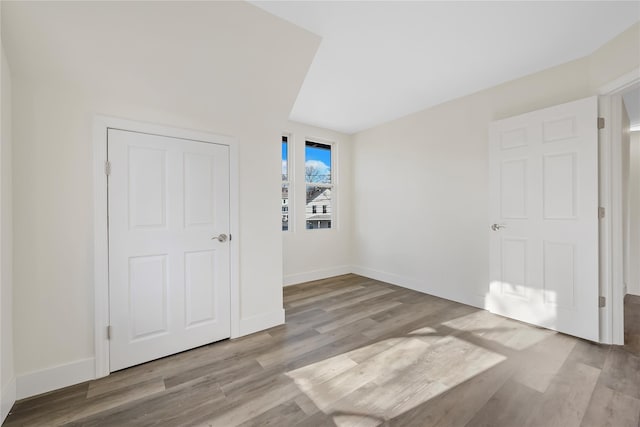 unfurnished bedroom featuring a closet and light wood-type flooring