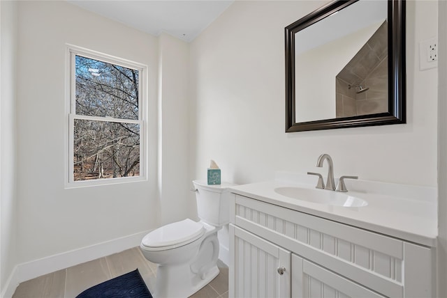 bathroom with plenty of natural light, toilet, and vanity