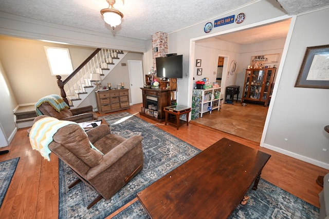 651 Madison Ave, Lindenhurst, NY 11757 - living room with stairway, a textured ceiling, and wood finished floors