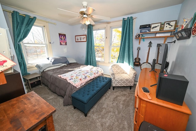 651 Madison Ave, Lindenhurst, NY 11757 - bedroom with multiple windows, carpet, a baseboard heating unit, and ceiling fan