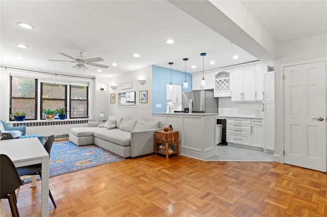 living room with ceiling fan and light parquet flooring