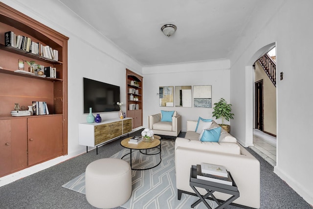 living room featuring built in shelves and light carpet