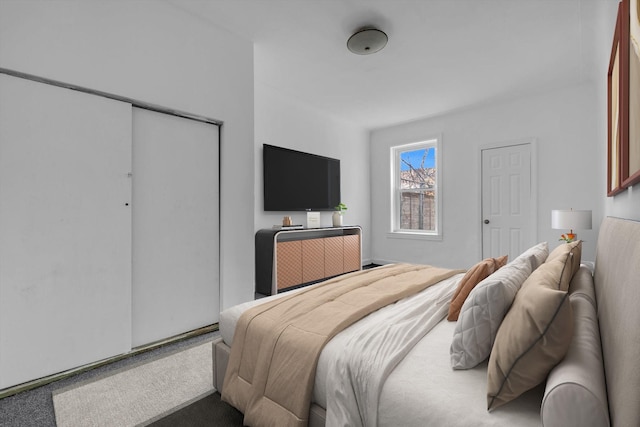 bedroom with carpet and a closet