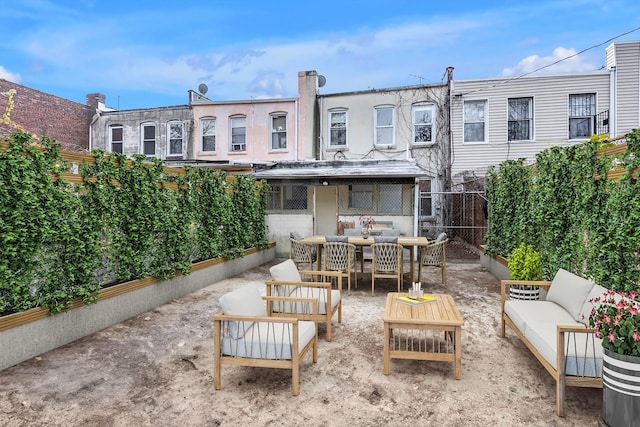 rear view of property with an outdoor living space