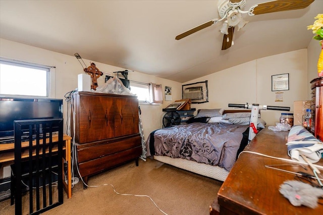 bedroom featuring light carpet, vaulted ceiling, multiple windows, and ceiling fan