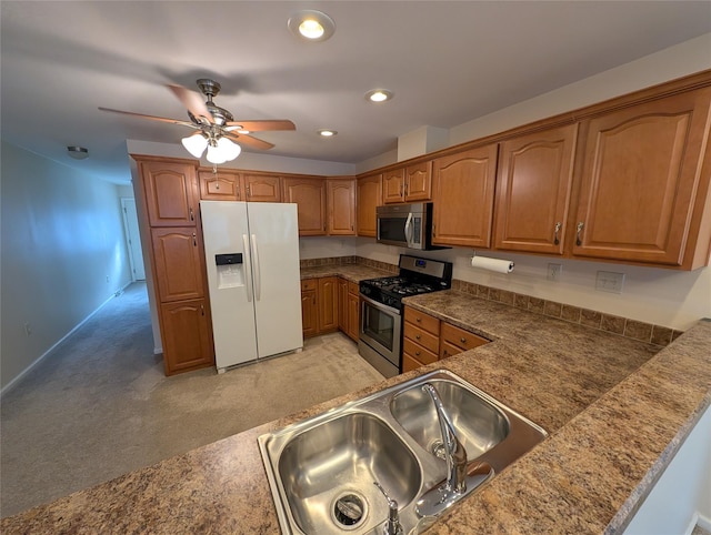 kitchen featuring light carpet, sink, ceiling fan, and stainless steel appliances