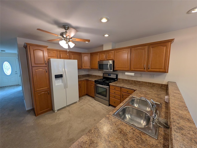 kitchen with light carpet, stainless steel appliances, ceiling fan, and sink