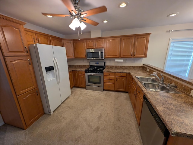 kitchen featuring light carpet, appliances with stainless steel finishes, ceiling fan, and sink