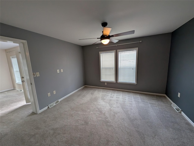 unfurnished room featuring ceiling fan and light colored carpet