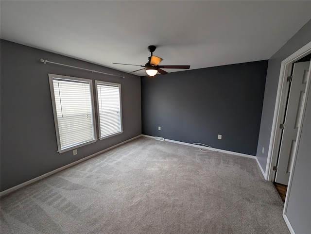 unfurnished room featuring ceiling fan and light carpet