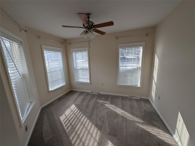 spare room with carpet and ceiling fan