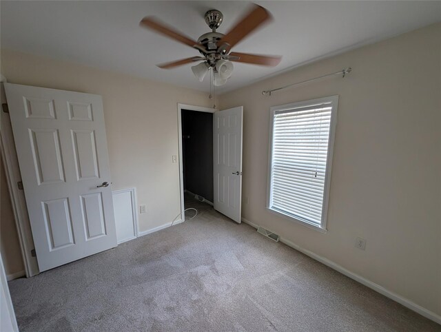 unfurnished bedroom featuring ceiling fan and light colored carpet