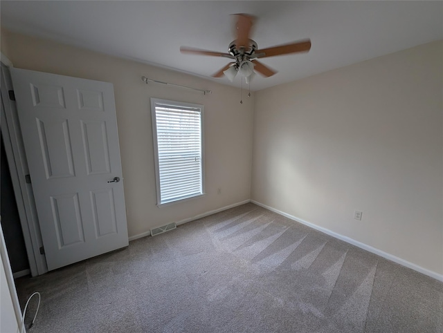 empty room with carpet and ceiling fan