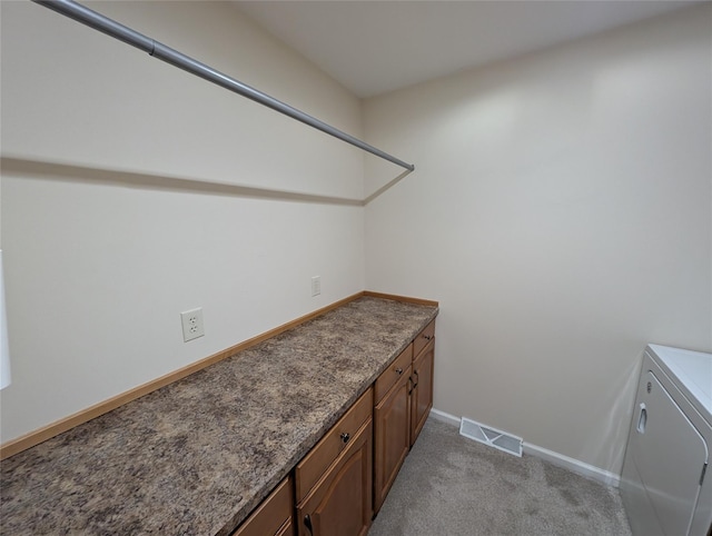 interior space with light colored carpet and washer / clothes dryer