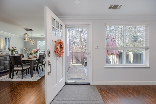 doorway to outside featuring dark hardwood / wood-style flooring, a healthy amount of sunlight, and ornamental molding