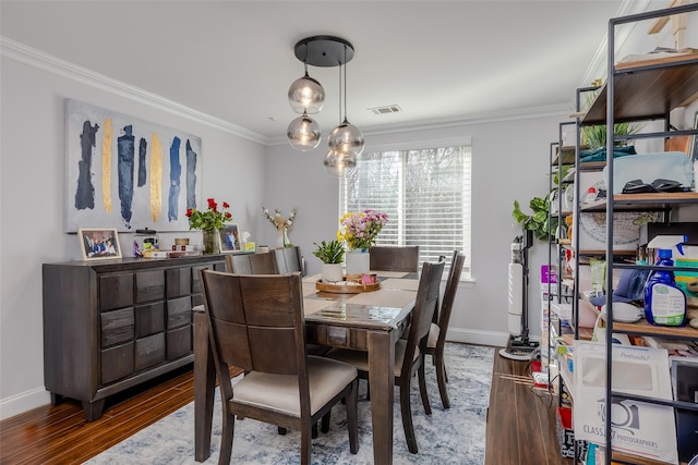 dining area with crown molding and dark hardwood / wood-style floors