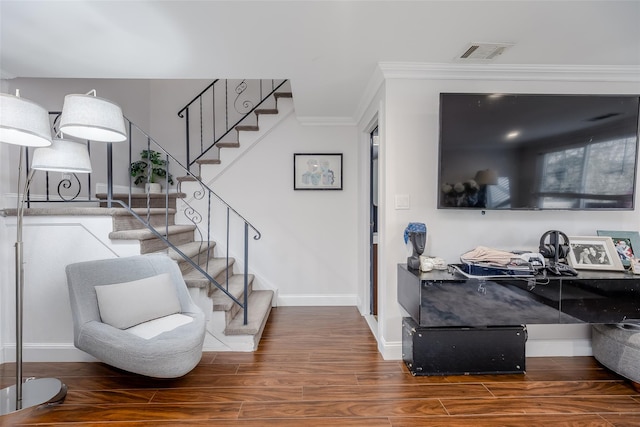 interior space featuring crown molding and dark wood-type flooring