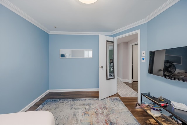 bedroom with dark hardwood / wood-style flooring and crown molding