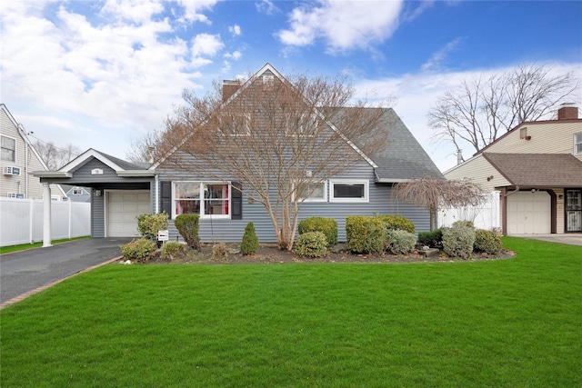 view of front facade with a front yard and a garage