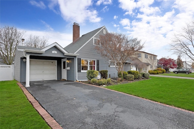 view of front facade with a front yard and a garage