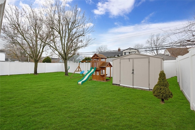 view of yard with a playground and a shed