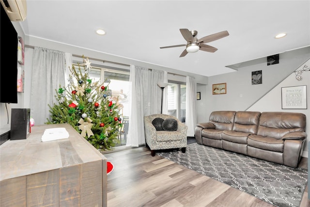 living room featuring ceiling fan and wood-type flooring