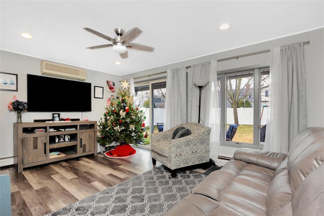 living room featuring plenty of natural light, ceiling fan, wood-type flooring, and a wall unit AC