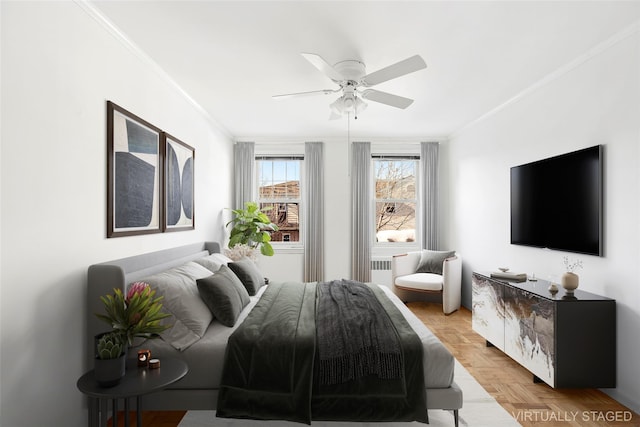 bedroom with ceiling fan, crown molding, and light parquet flooring