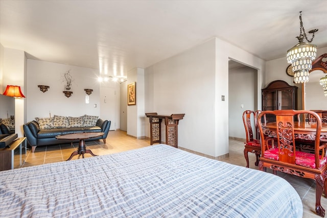 bedroom with light tile patterned floors and a chandelier