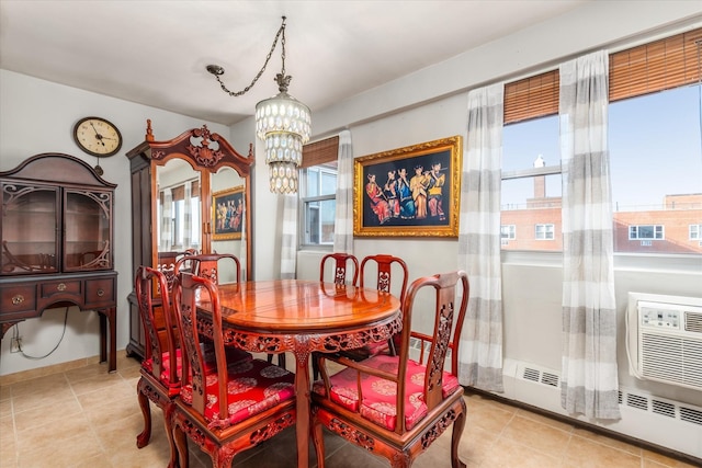 dining room with plenty of natural light, light tile patterned floors, and a chandelier