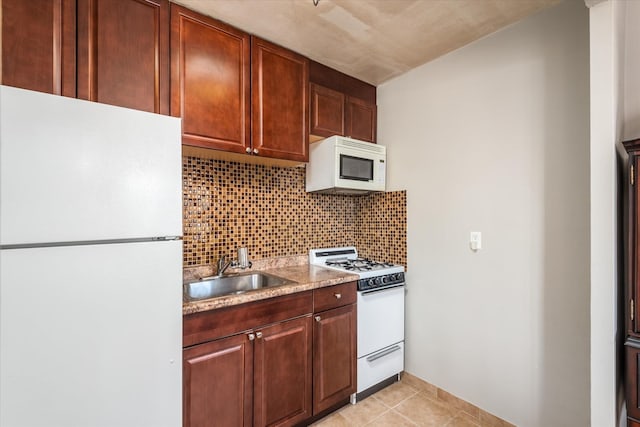 kitchen with decorative backsplash, light stone countertops, white appliances, sink, and light tile patterned flooring