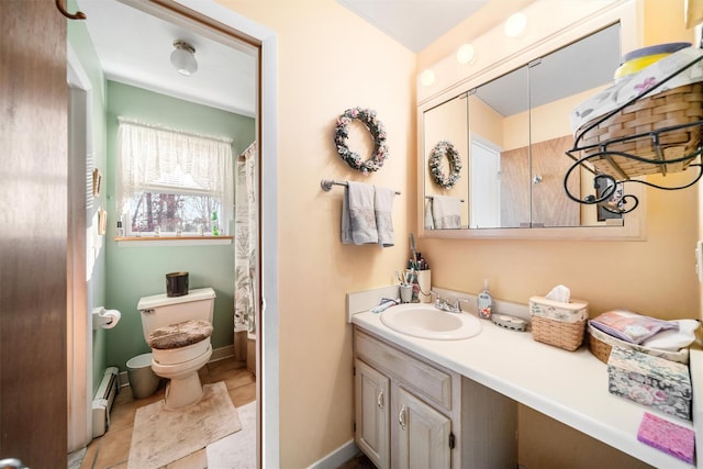 bathroom featuring tile patterned floors, vanity, a baseboard radiator, and toilet