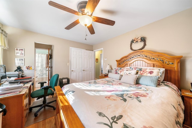 bedroom with ceiling fan, a closet, and hardwood / wood-style flooring