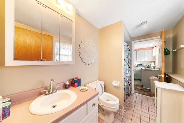 bathroom featuring tile patterned floors, vanity, and toilet