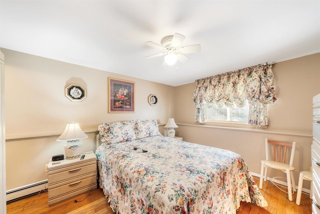 bedroom with ceiling fan, light hardwood / wood-style floors, and a baseboard radiator