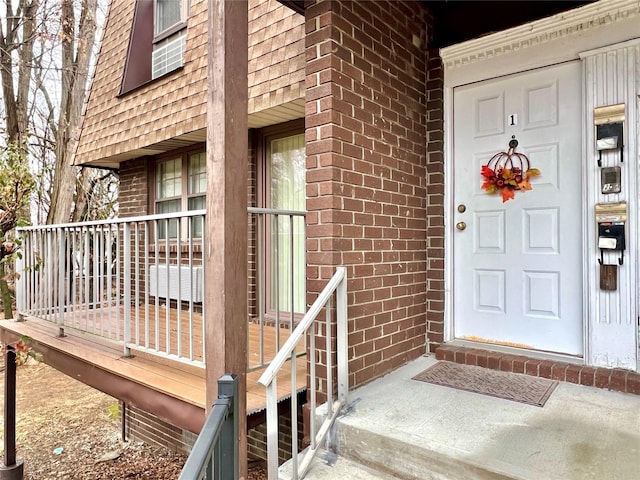 view of exterior entry featuring covered porch