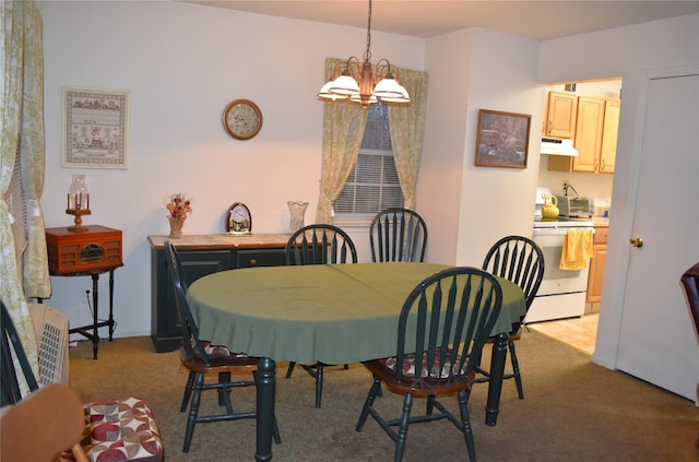 dining area featuring light colored carpet and a notable chandelier