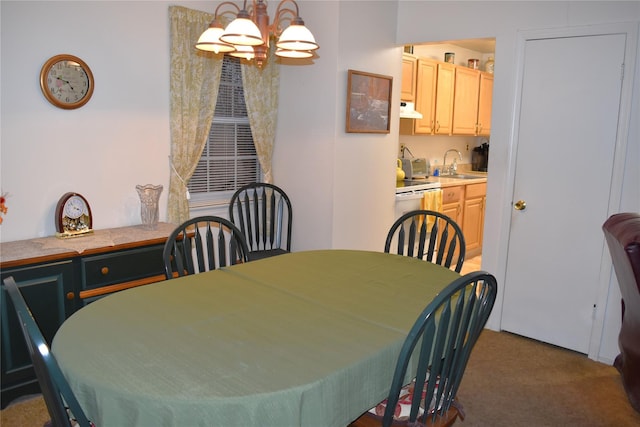 dining space featuring dark carpet, sink, and an inviting chandelier