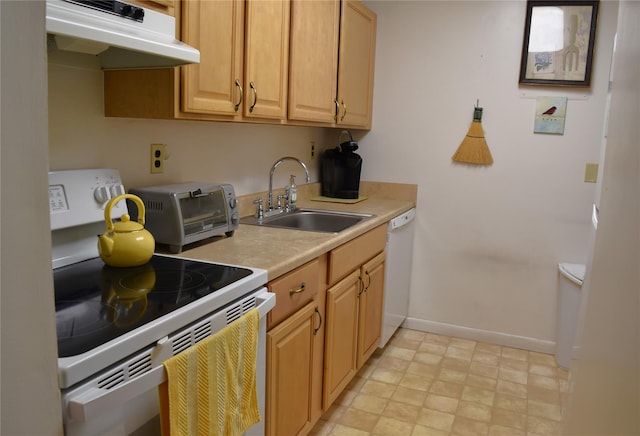 kitchen featuring dishwasher, stove, sink, and light brown cabinetry