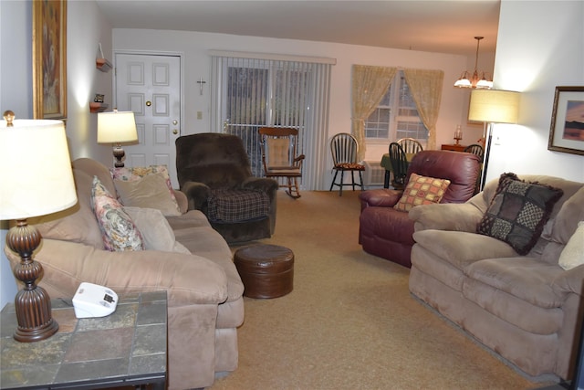 living room featuring carpet flooring and a notable chandelier