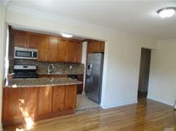 kitchen with light hardwood / wood-style flooring, decorative backsplash, ornamental molding, appliances with stainless steel finishes, and kitchen peninsula