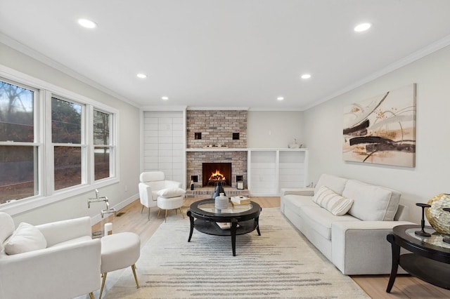 living room with a fireplace, light hardwood / wood-style flooring, and crown molding