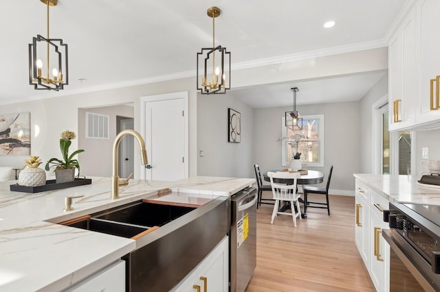 kitchen featuring pendant lighting, light wood-type flooring, and white cabinetry